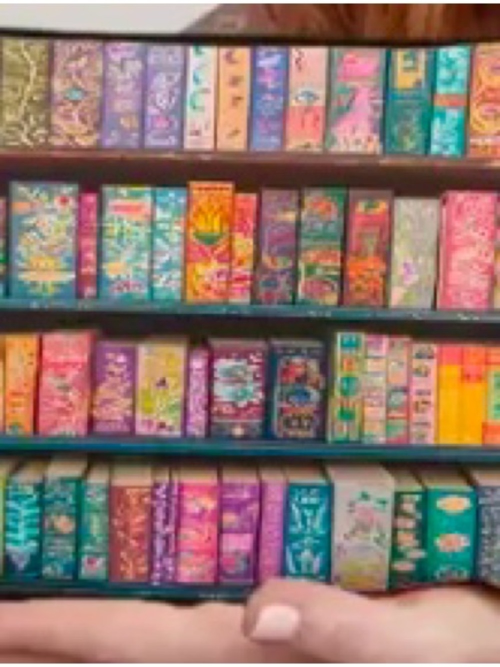 Colorful Cosmetic Bag Organizer. Multi colored books miniatures adornments
